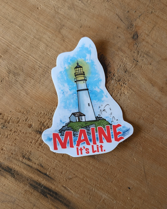 Contour cut vinyl sticker featuring a lighthouse illustration and red text reading “Maine it’s lit.”