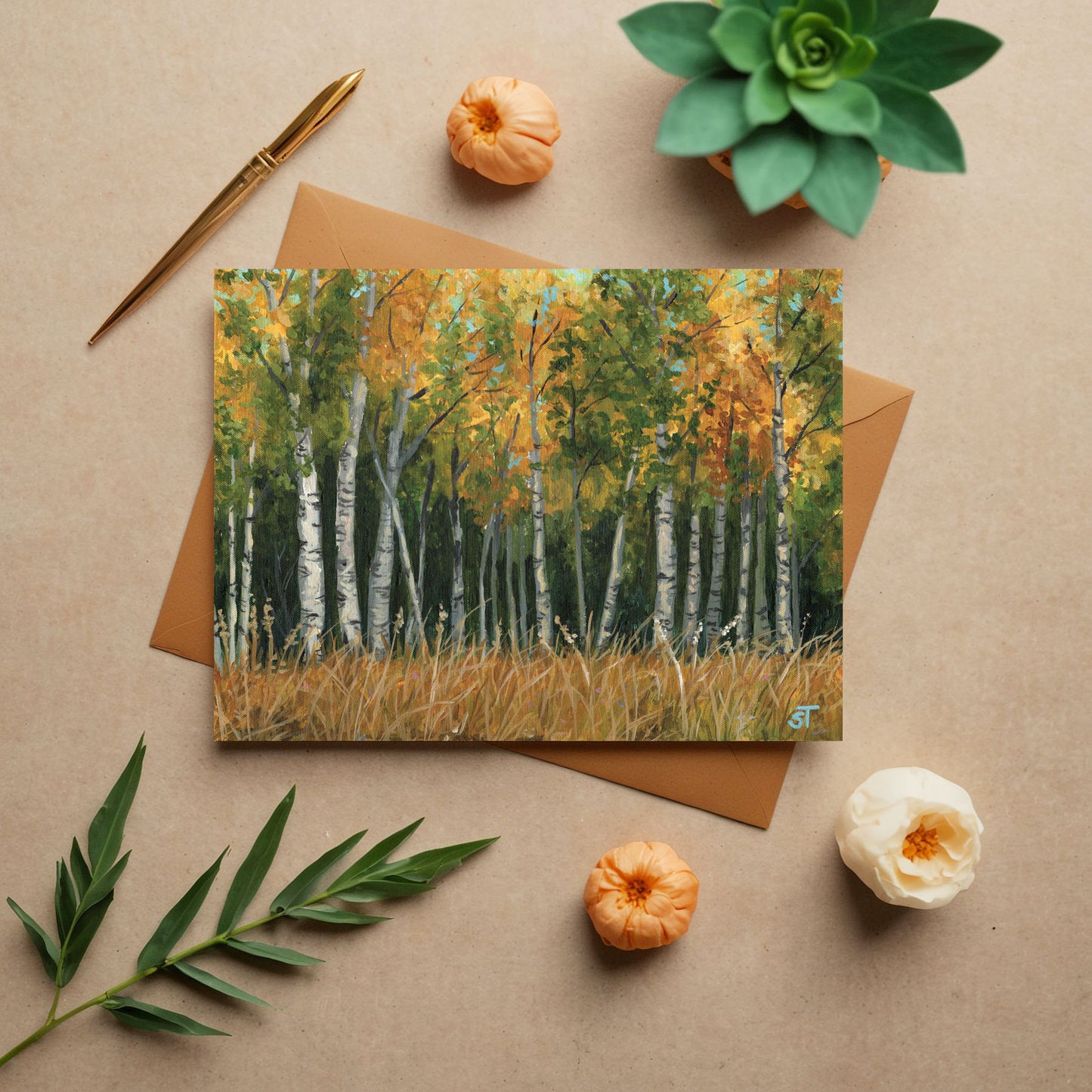 Autumn-themed greeting card with a forest design on a beige surface with decorative elements.