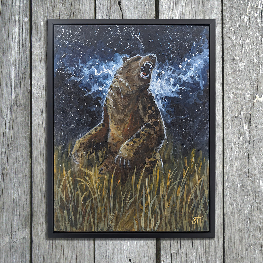 Flat lay of an original cryptid painting depicting the legendary Nandi Bear rearing in tall grass beneath a star-filled night sky, breath swirling in the cold air. Presented in a black frame, laid on wooden background.