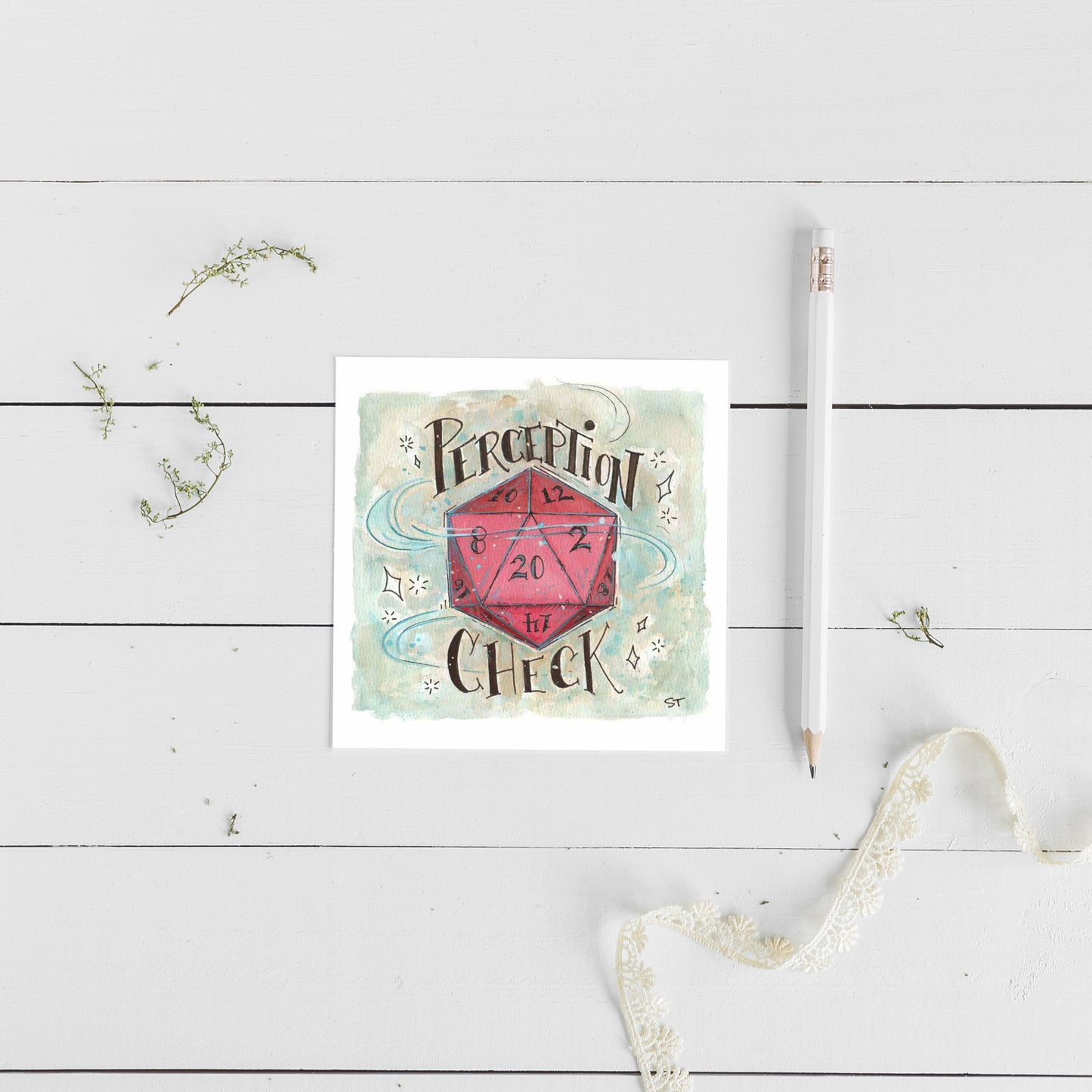Card with a pink D20 and text on a white wooden surface with a pencil and decorative elements.