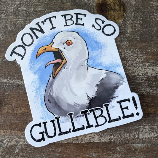 A sticker with an illustration of a seagull and the phrase 'DON'T BE SO GULLIBLE!' in bold letters.